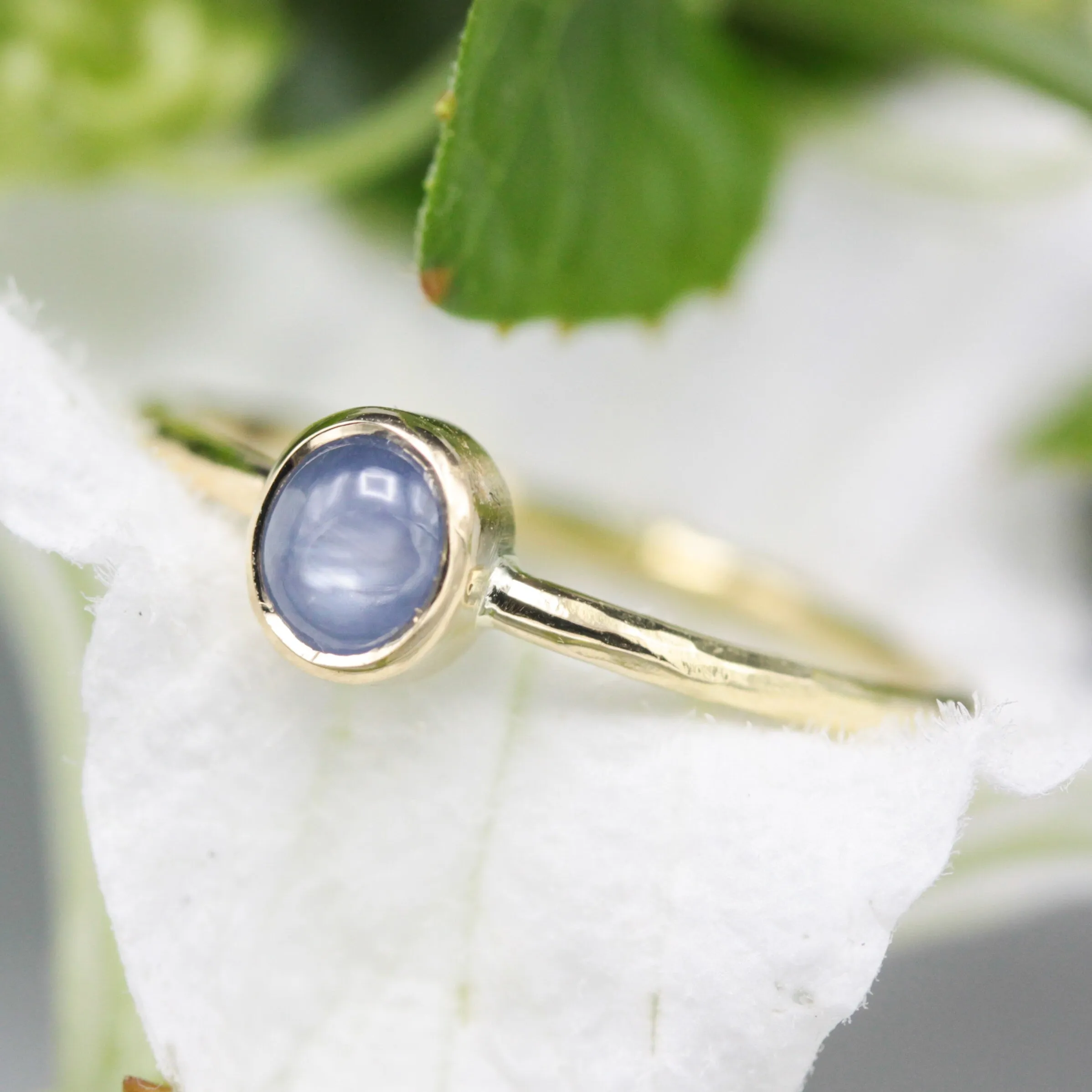 Oval Blue star sapphire in bezel settings with 18k gold texture band