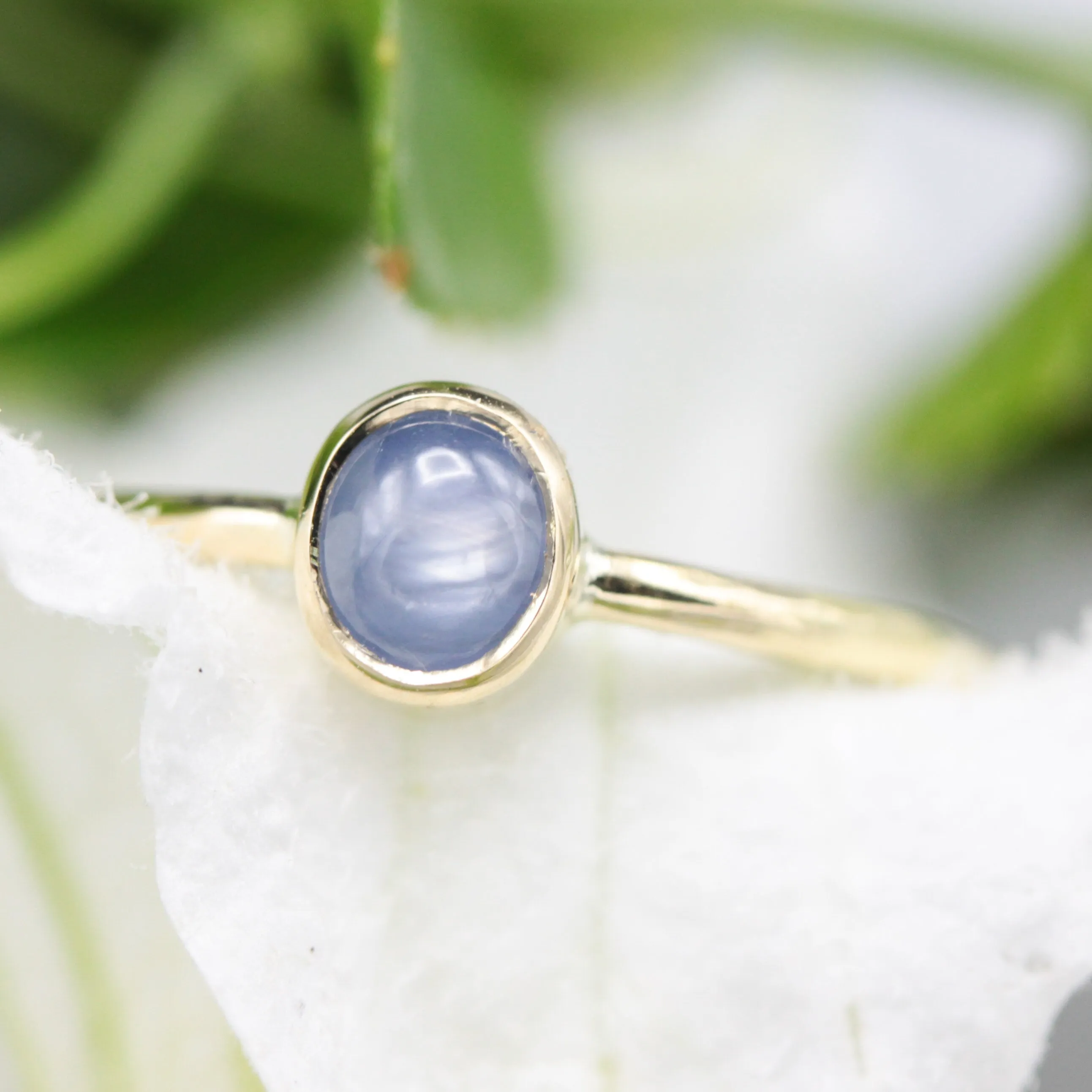 Oval Blue star sapphire in bezel settings with 18k gold texture band