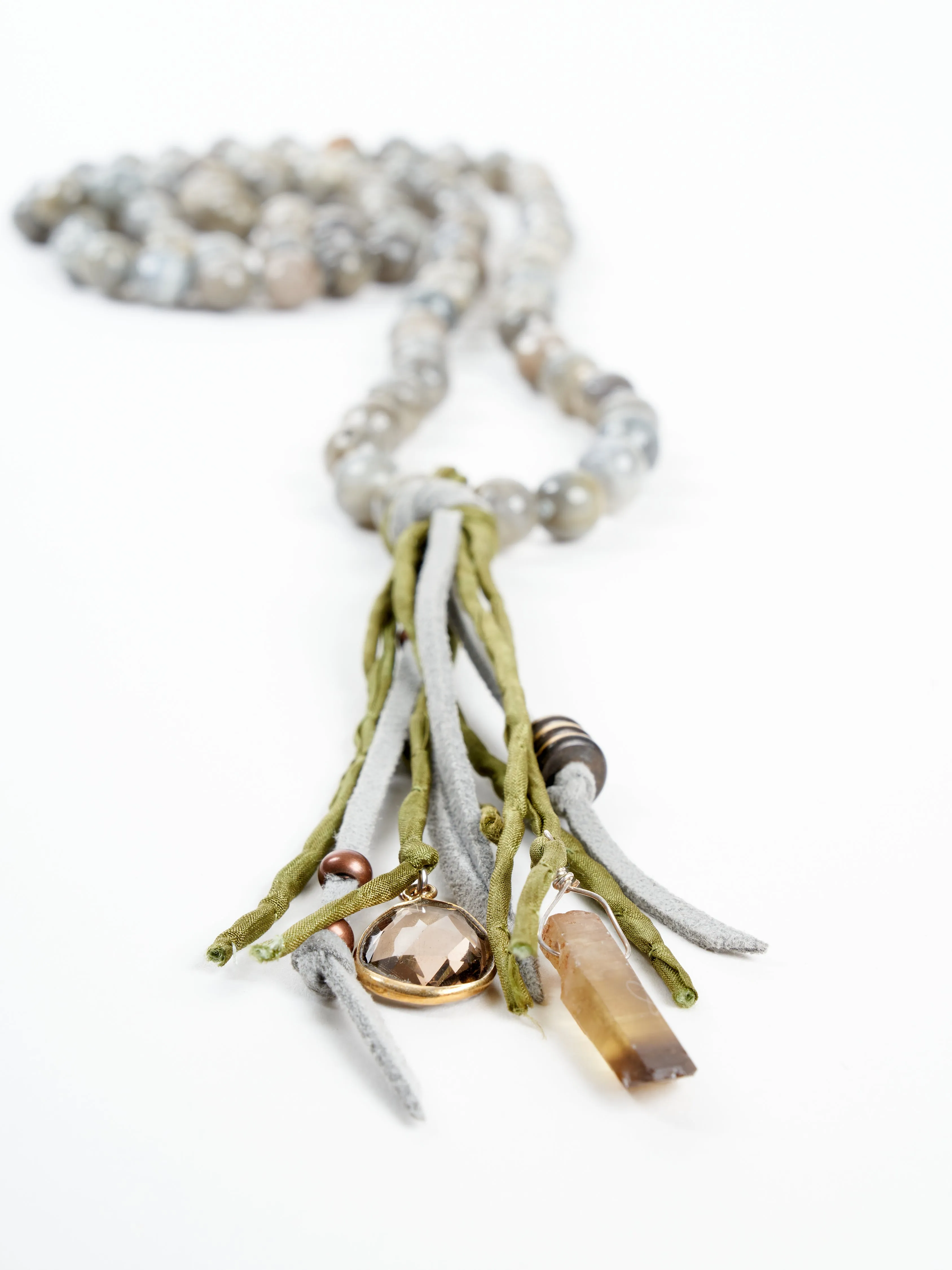 precious stone with leather and silk tassel